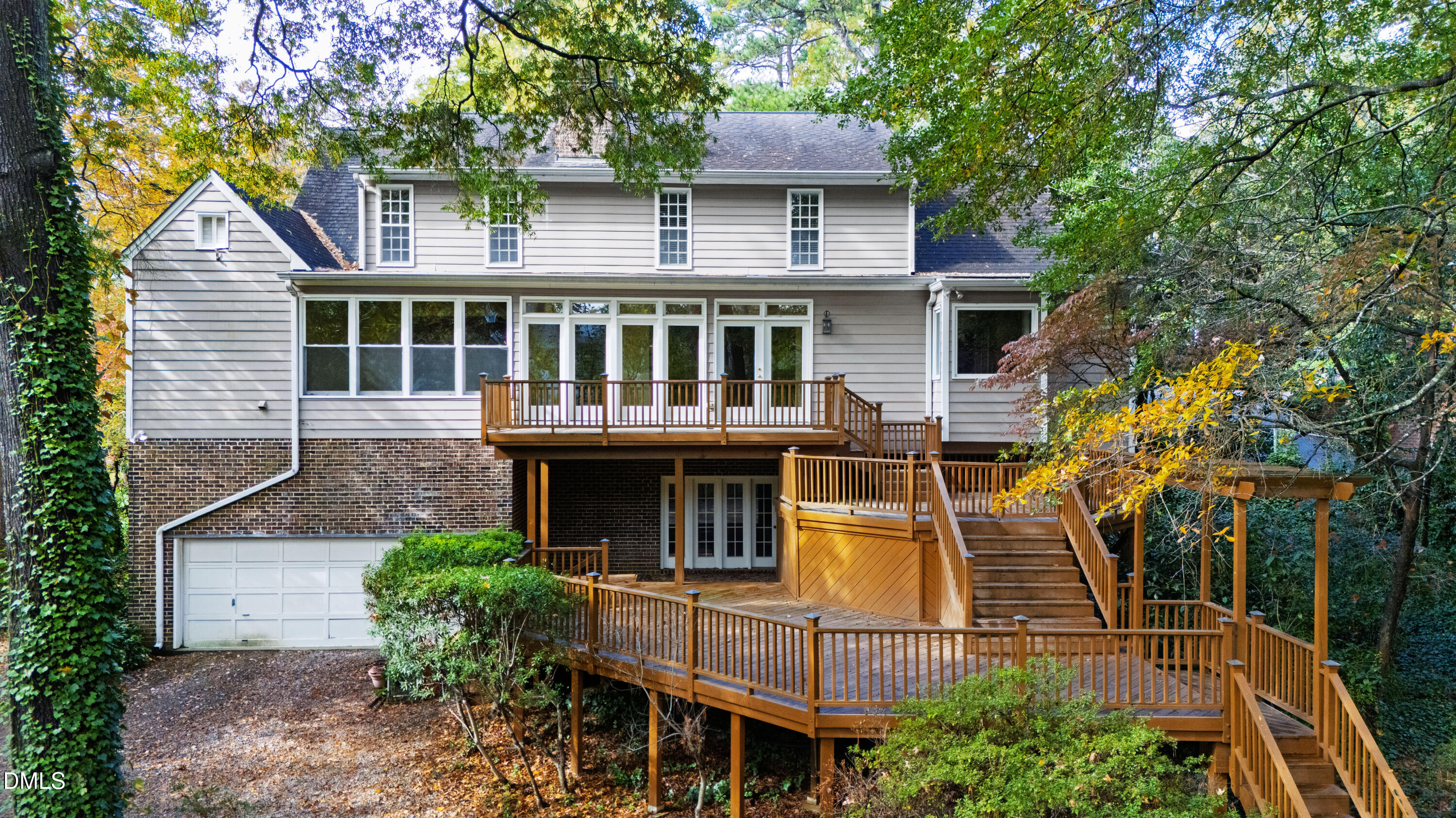 3324 Landor Road Raleigh, NC 27609 - Photo 66 of 69 a view of a white house with large windows and a small yard