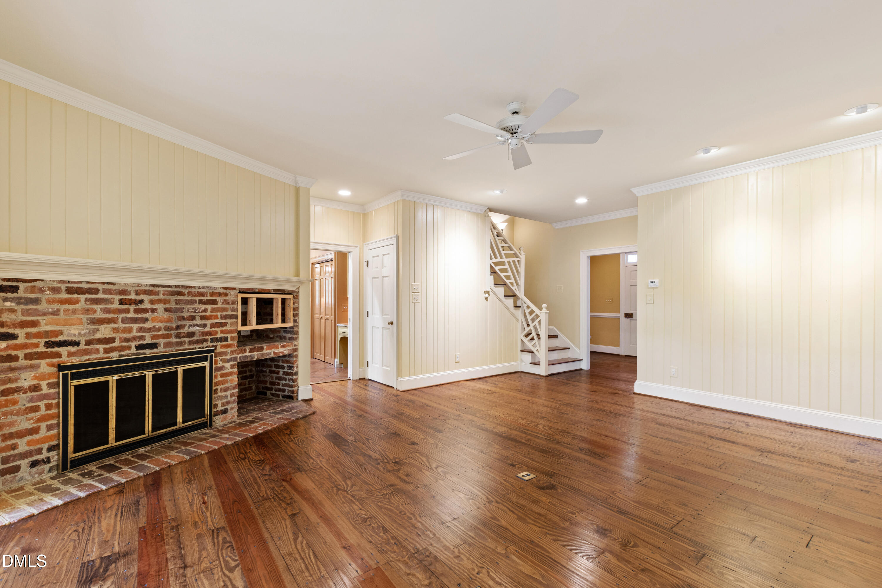 3324 Landor Road Raleigh, NC 27609 - Photo 9 of 69 an empty room with wooden floor kitchen view and a kitchen