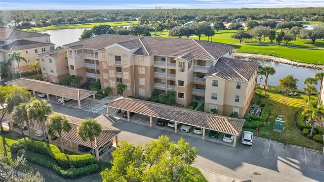an aerial view of a house with a garden and lake view