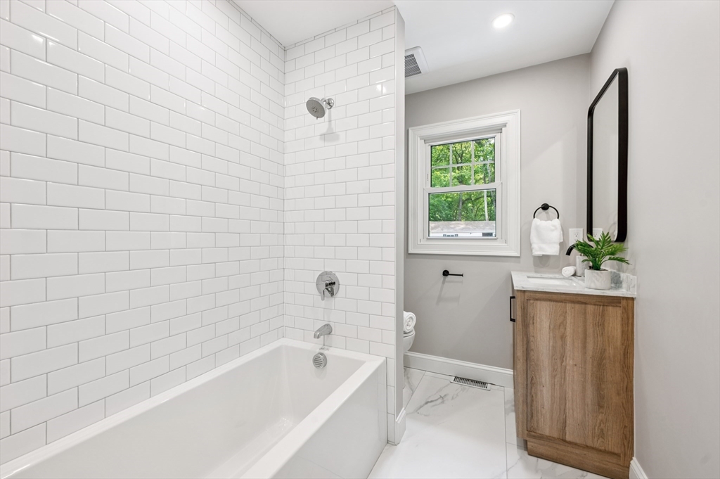 37 Hillside Road Boxford, MA 01921 - Photo 12 of 27 a bathroom with a bathtub a sink a window and a shower