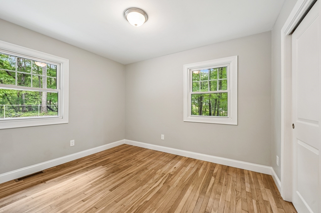 37 Hillside Road Boxford, MA 01921 - Photo 15 of 27 a view of an empty room with wooden floor and a window