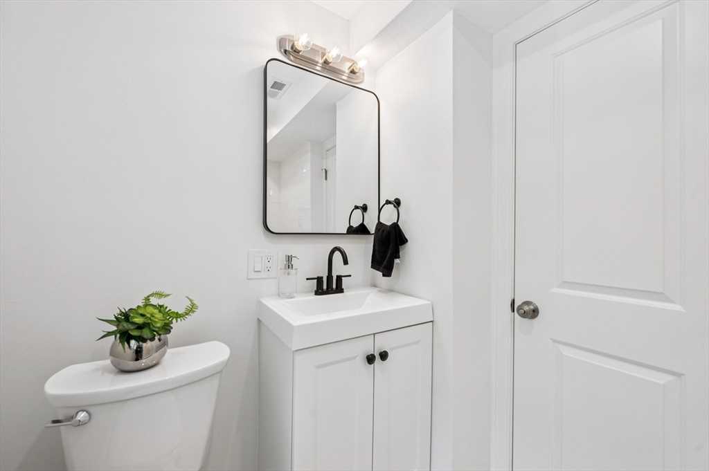 37 Hillside Road Boxford, MA 01921 - Photo 16 of 27 a bathroom with a toilet sink and mirror