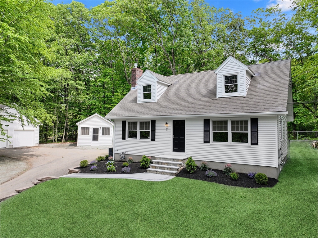 37 Hillside Road Boxford, MA 01921 - Photo 2 of 27 a front view of a house with a garden
