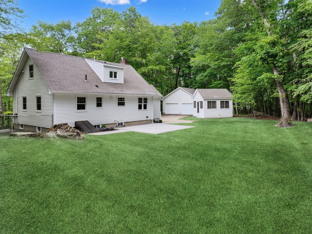 37 Hillside Road Boxford, MA 01921 - Photo 25 of 27 a front view of a house with a garden and yard