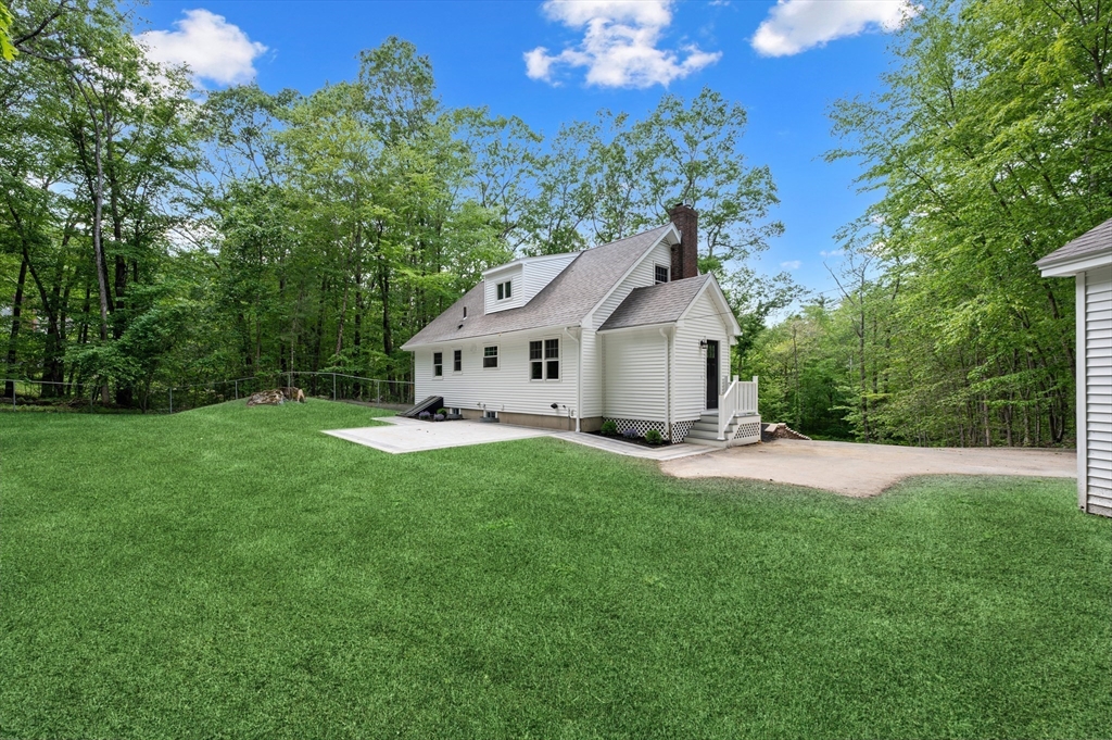37 Hillside Road Boxford, MA 01921 - Photo 26 of 27 a view of a white house in front of a big yard with large trees