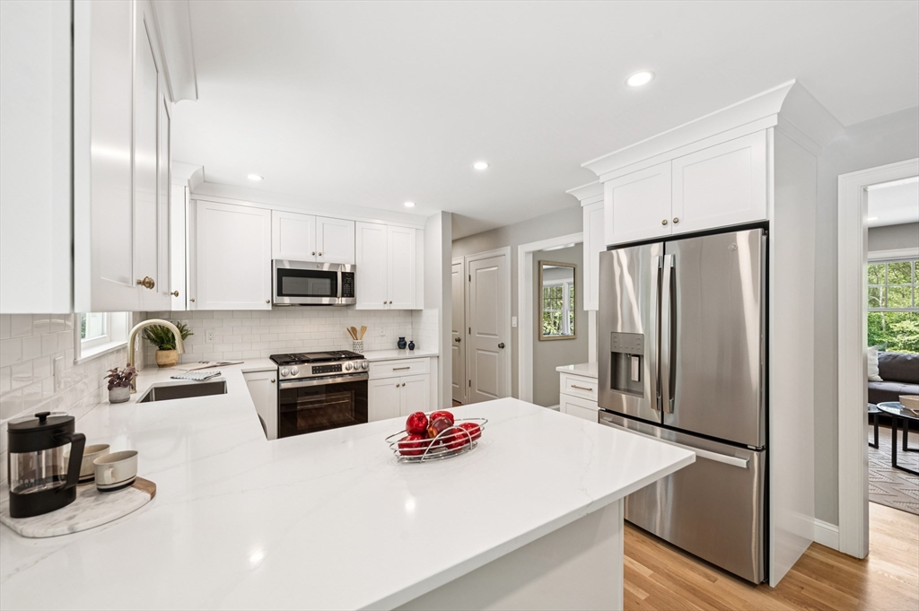 37 Hillside Road Boxford, MA 01921 - Photo 4 of 27 a kitchen with refrigerator a stove and cabinets