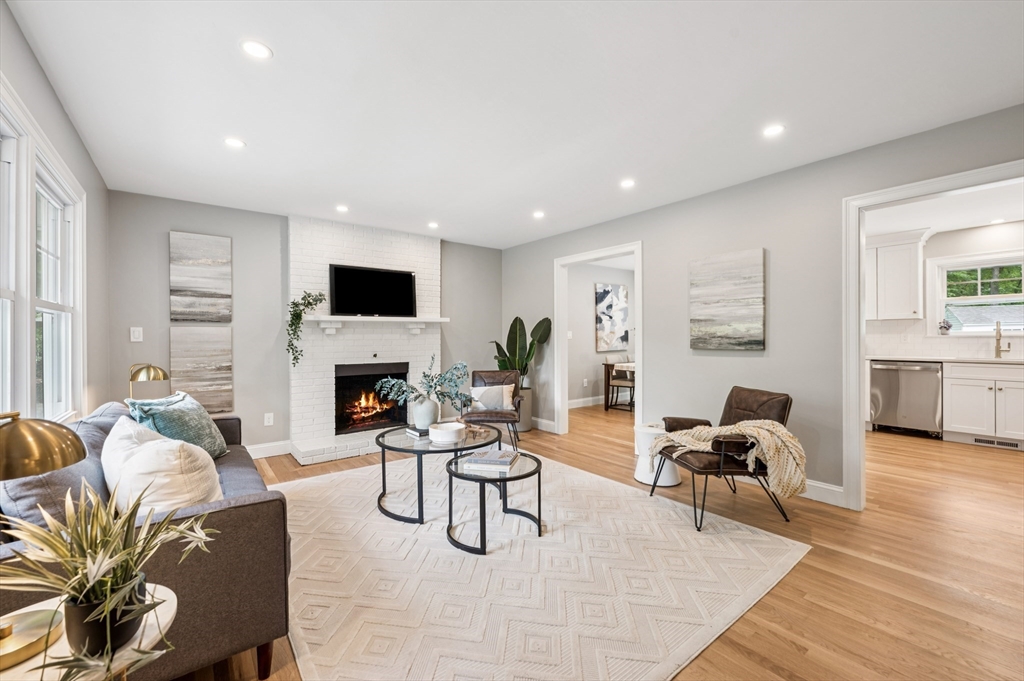 37 Hillside Road Boxford, MA 01921 - Photo 6 of 27 a living room with furniture a fireplace and a flat screen tv