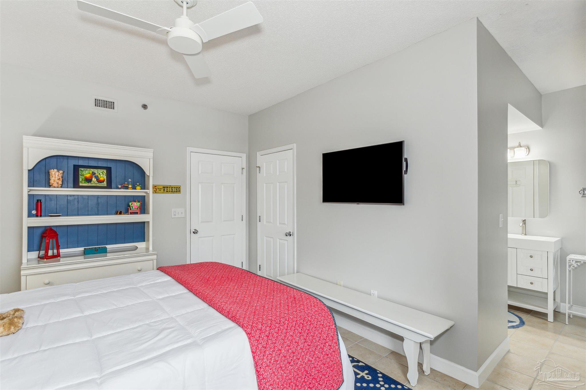 800 Fort Pickens Road, Unit 204 Pensacola Beach, FL 32561 - Photo 33 of 45 a bedroom with a bed and a flat screen tv