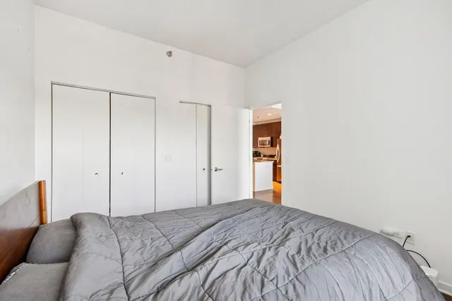 a bedroom with a bed and cabinets