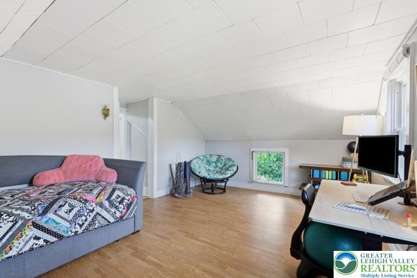 2021 Leithsville Road Hellertown, PA 18055 - Photo 29 of 39 Bright hardwood floors and sloped ceilings define this adaptable bonus room, perfect for various activities.