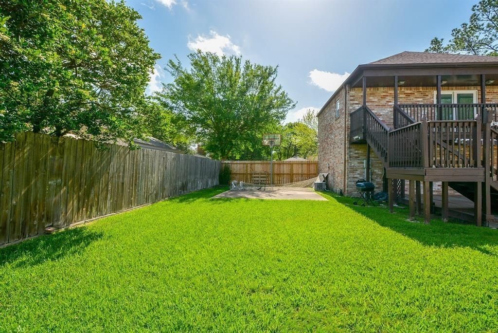 11502 Wickersham Lane Houston, TX 77077 - Photo 18 of 22 a view of backyard with a garden and deck