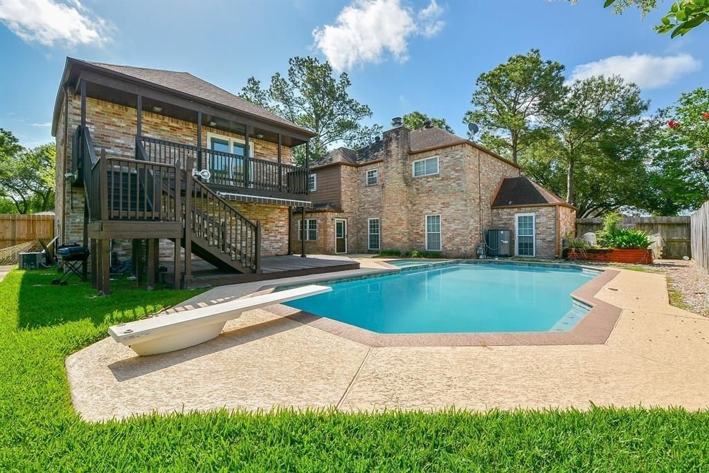 11502 Wickersham Lane Houston, TX 77077 - Photo 19 of 22 a front view of a house with a yard and trees