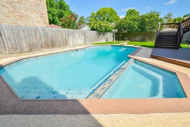 a view of a backyard with swimming pool