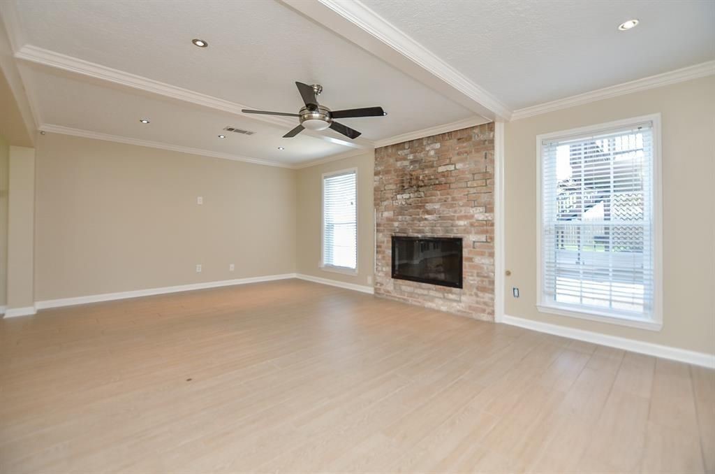 11502 Wickersham Lane Houston, TX 77077 - Photo 10 of 22 a view of an empty room with a fireplace and a window