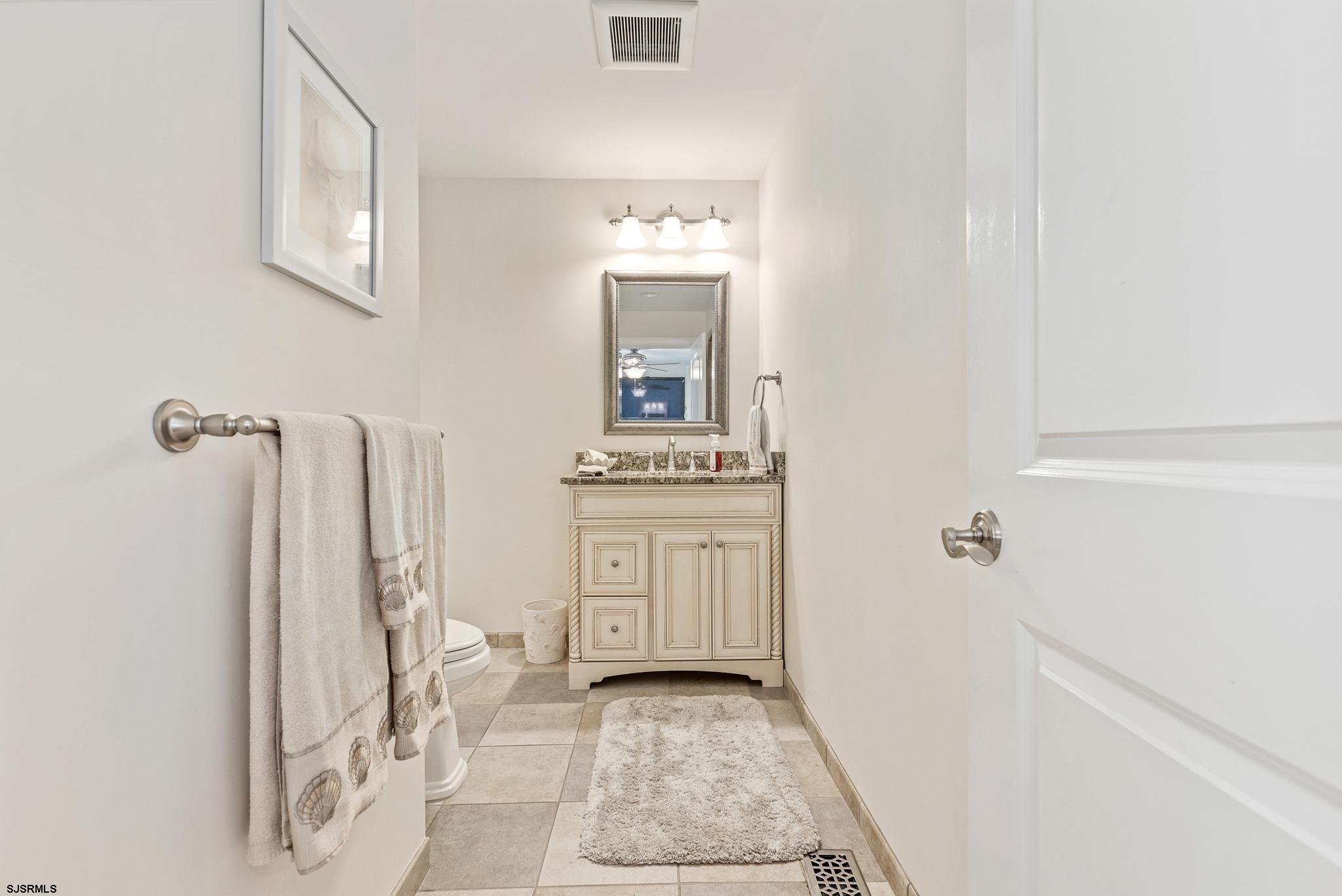 29 North Iroquois Avenue, Unit 6/16/26 FLEXIBLE WITH START DATE Margate City, NJ 08402 - Photo 15 of 40 a bathroom with a granite countertop sink and a mirror