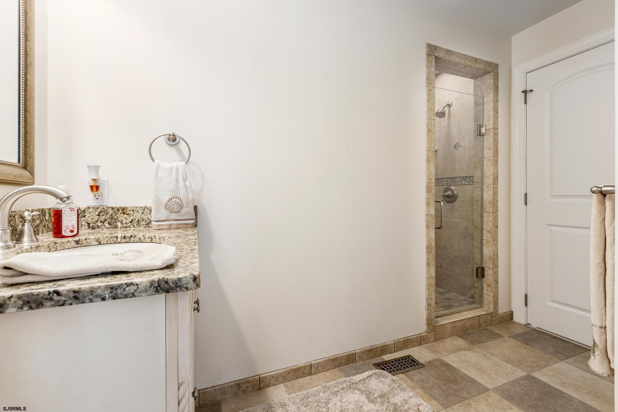 29 North Iroquois Avenue, Unit 6/16/26 FLEXIBLE WITH START DATE Margate City, NJ 08402 - Photo 16 of 40 a bathroom with a sink and a mirror
