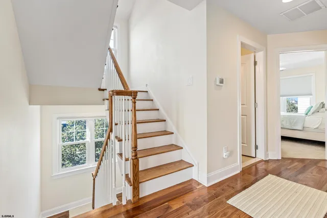 a view of staircase with white walls and window