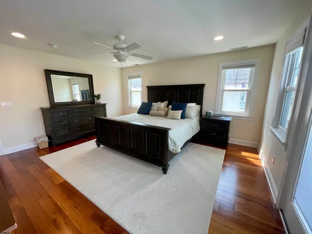 a bedroom with a bed window and a dresser
