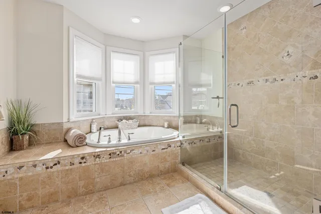 a bathroom with a tub a sink and a window