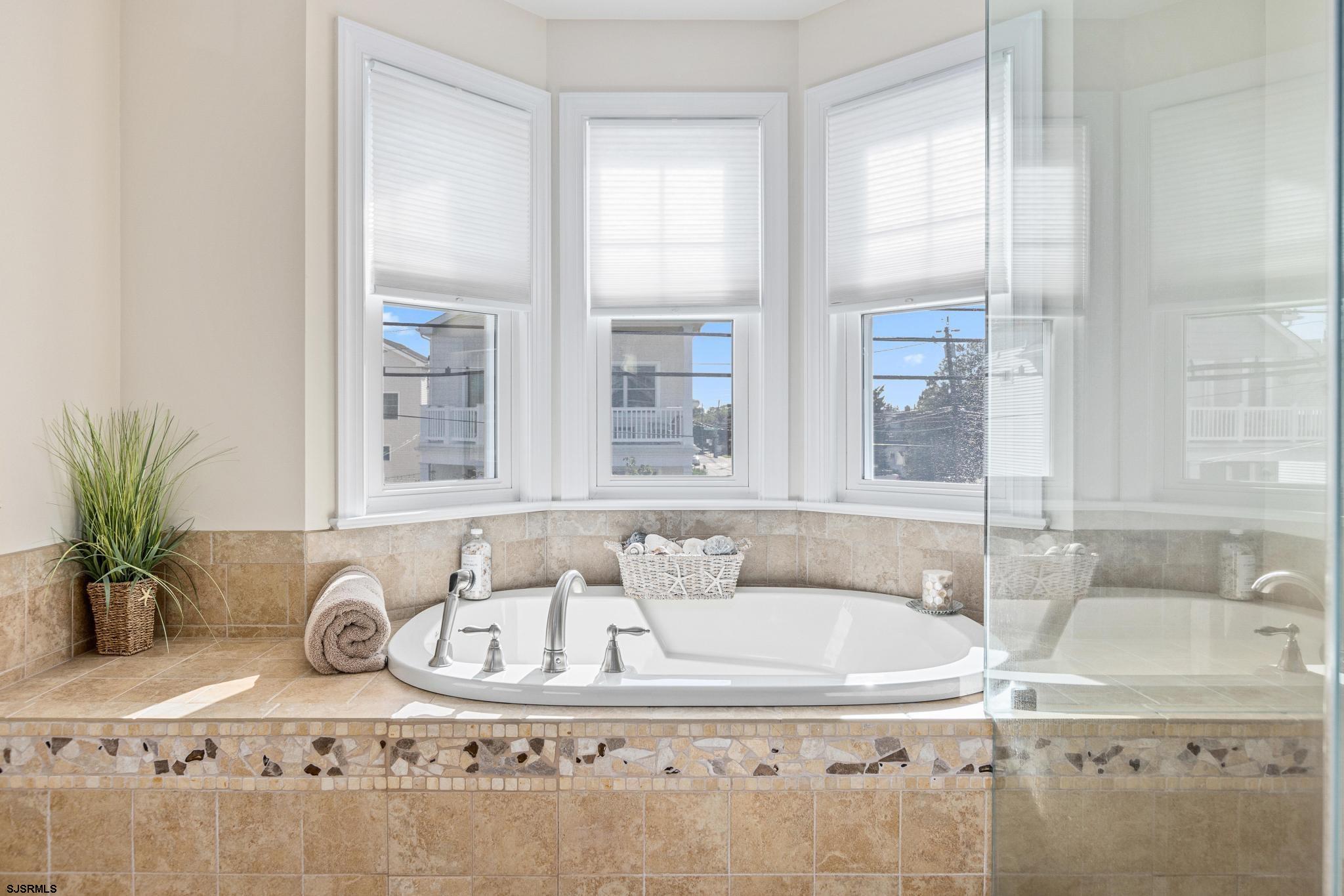 29 North Iroquois Avenue, Unit 6/16/26 FLEXIBLE WITH START DATE Margate City, NJ 08402 - Photo 30 of 40 a bathroom with a granite countertop sink and a window