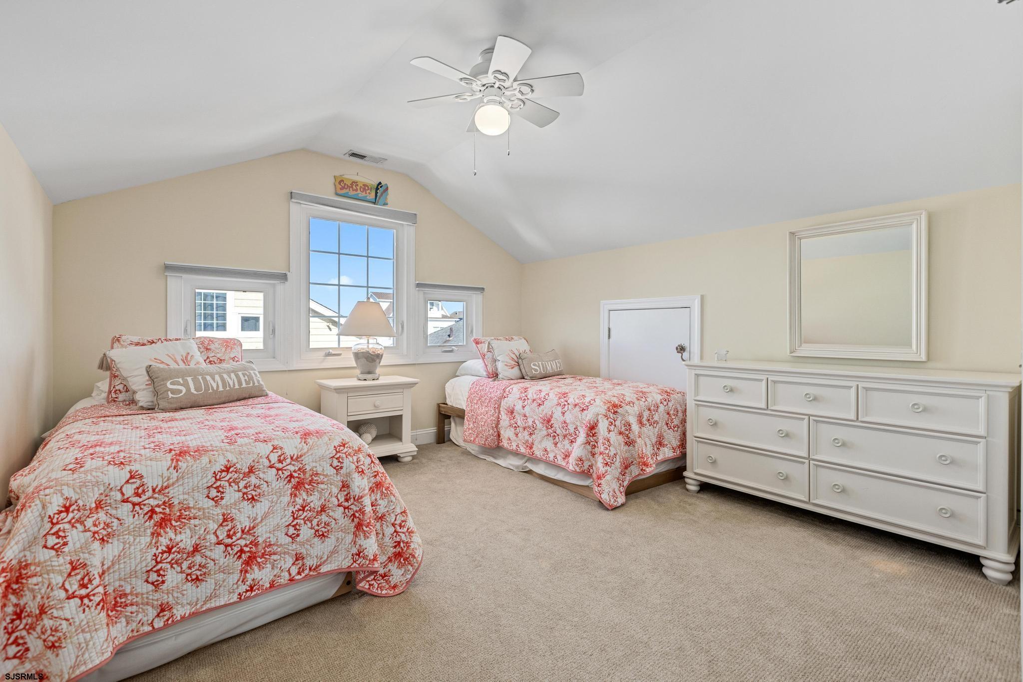 29 North Iroquois Avenue, Unit 6/16/26 FLEXIBLE WITH START DATE Margate City, NJ 08402 - Photo 34 of 40 a bedroom with two beds and a chandelier