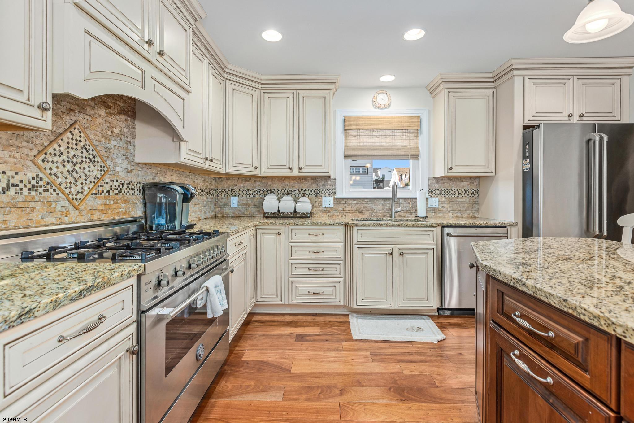 29 North Iroquois Avenue, Unit 6/16/26 FLEXIBLE WITH START DATE Margate City, NJ 08402 - Photo 7 of 40 a kitchen with stainless steel appliances granite countertop a stove and a sink