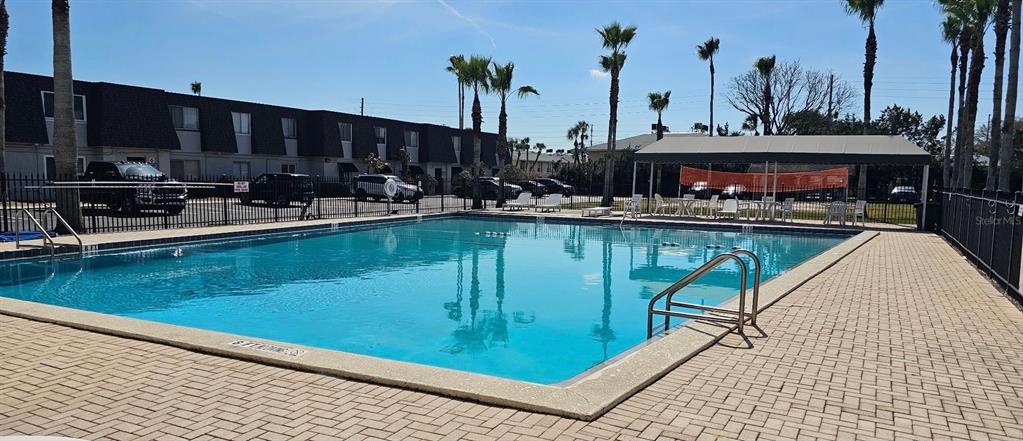 1928 South Conway Road, Unit 17 Orlando, FL 32812 - Photo 5 of 13 a view of a swimming pool with outdoor seating