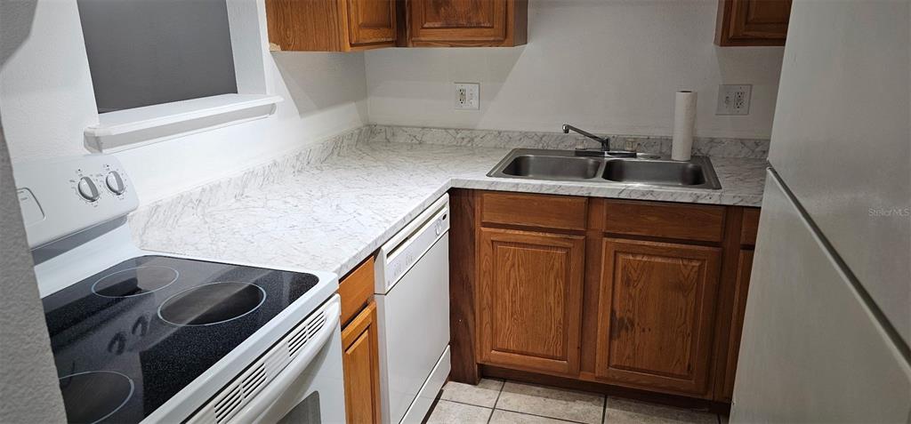 1928 South Conway Road, Unit 17 Orlando, FL 32812 - Photo 8 of 13 a kitchen with a sink and a stove top oven