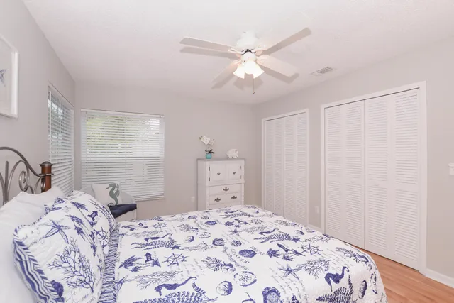 a bedroom with a large bed and a chandelier