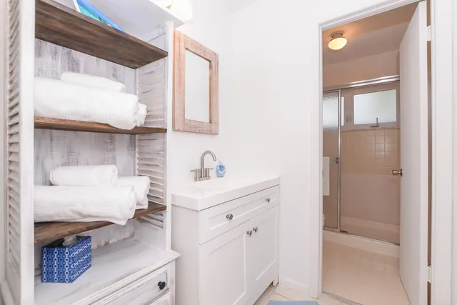 a bathroom with a sink vanity and a mirror