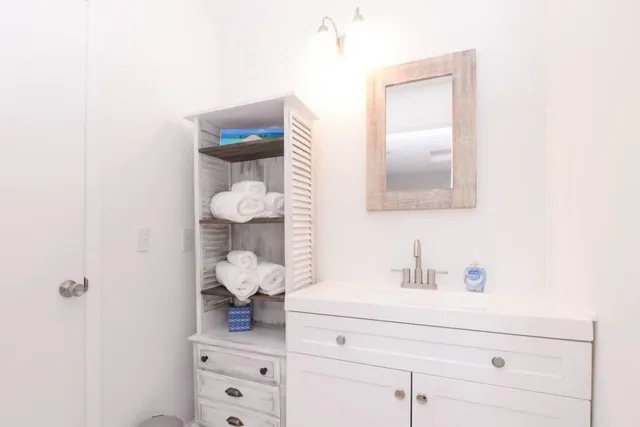 a white toilet sitting next to a bathroom sink