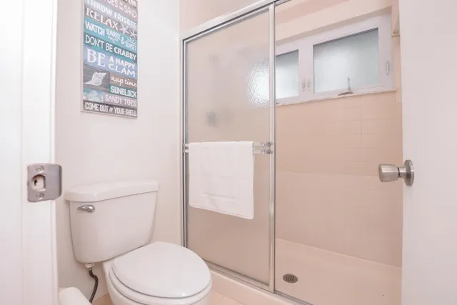 a bedroom with two beds and a chandelier