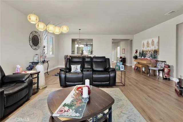 a living room with furniture a fireplace a rug and a window