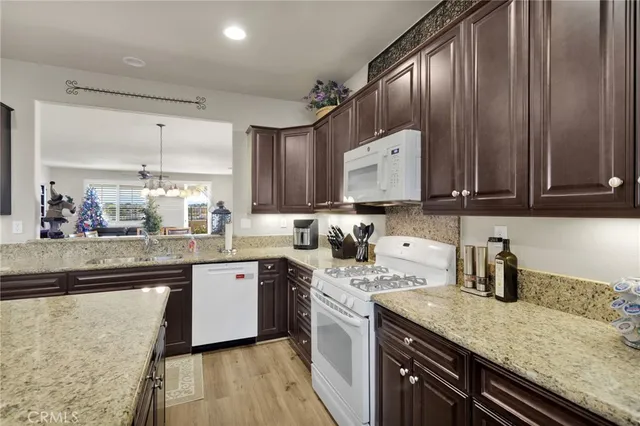 a kitchen with stainless steel appliances granite countertop wooden cabinets a sink and dishwasher