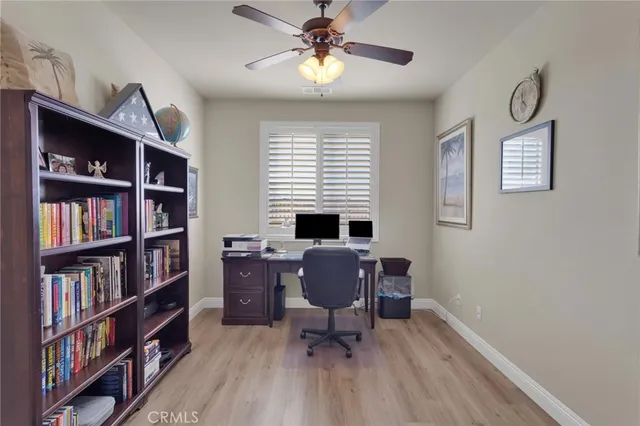 a view of a workspace with furniture and a window