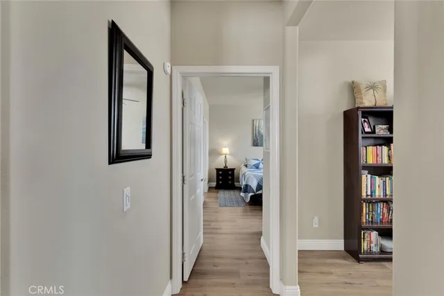 a spacious bedroom with a bed a couch and a chandelier