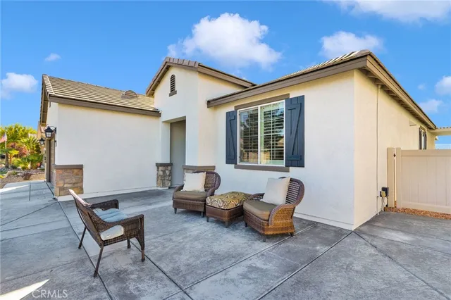 a backyard of a house with table and chairs