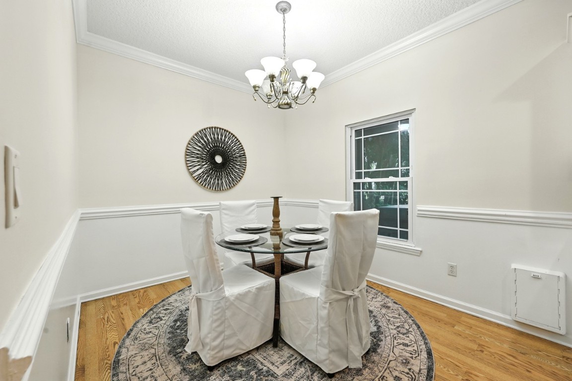 86168 Remsenburg Drive Fernandina Beach, FL 32034 - Photo 14 of 68 a dining room with chandelier and wooden floor