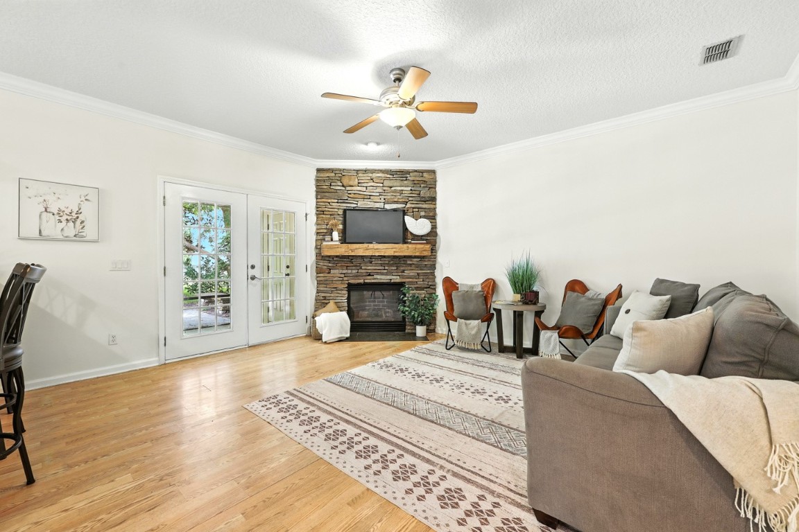 86168 Remsenburg Drive Fernandina Beach, FL 32034 - Photo 17 of 68 a living room with furniture a fireplace and a chandelier