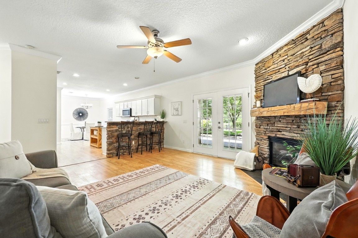 86168 Remsenburg Drive Fernandina Beach, FL 32034 - Photo 18 of 68 a living room with furniture a fireplace and a flat screen tv