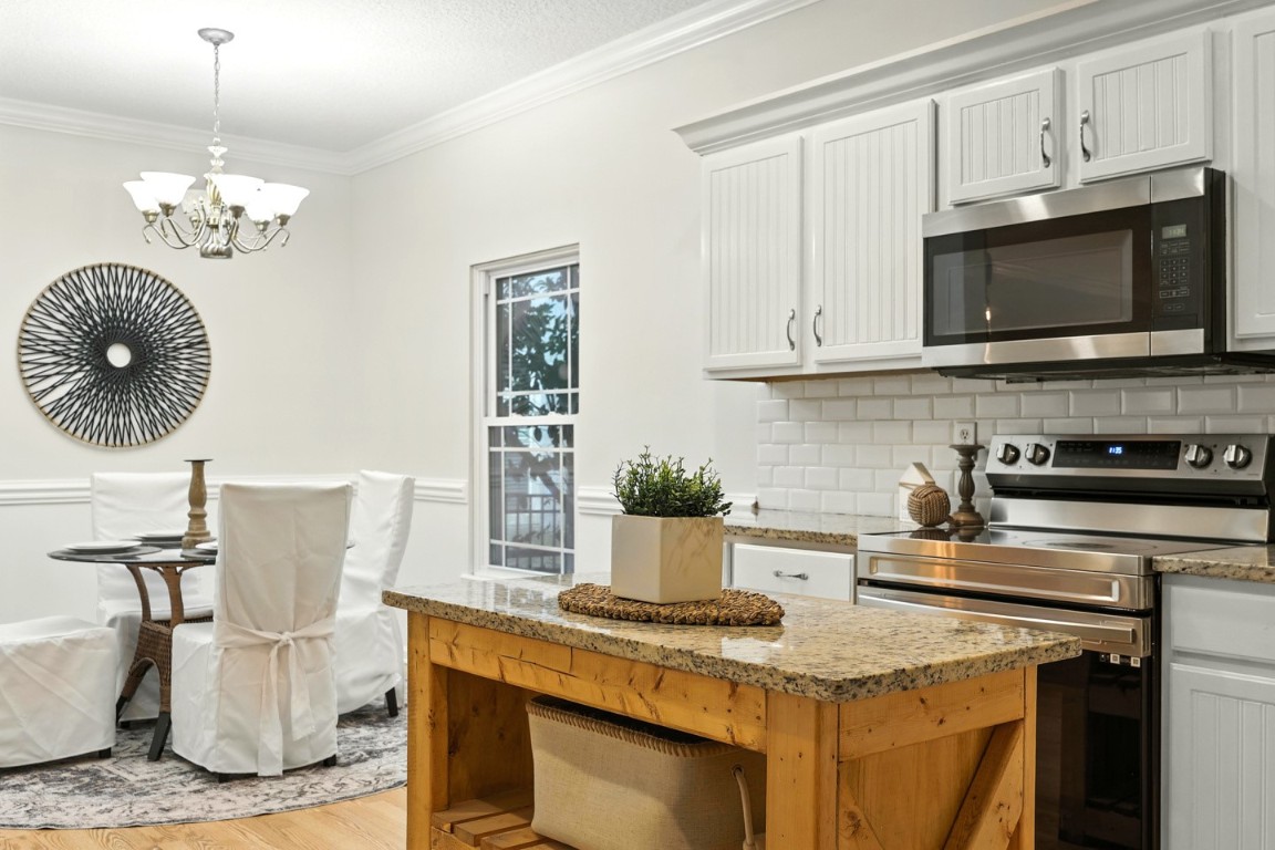 86168 Remsenburg Drive Fernandina Beach, FL 32034 - Photo 7 of 68 a kitchen with a stove and a white cabinets
