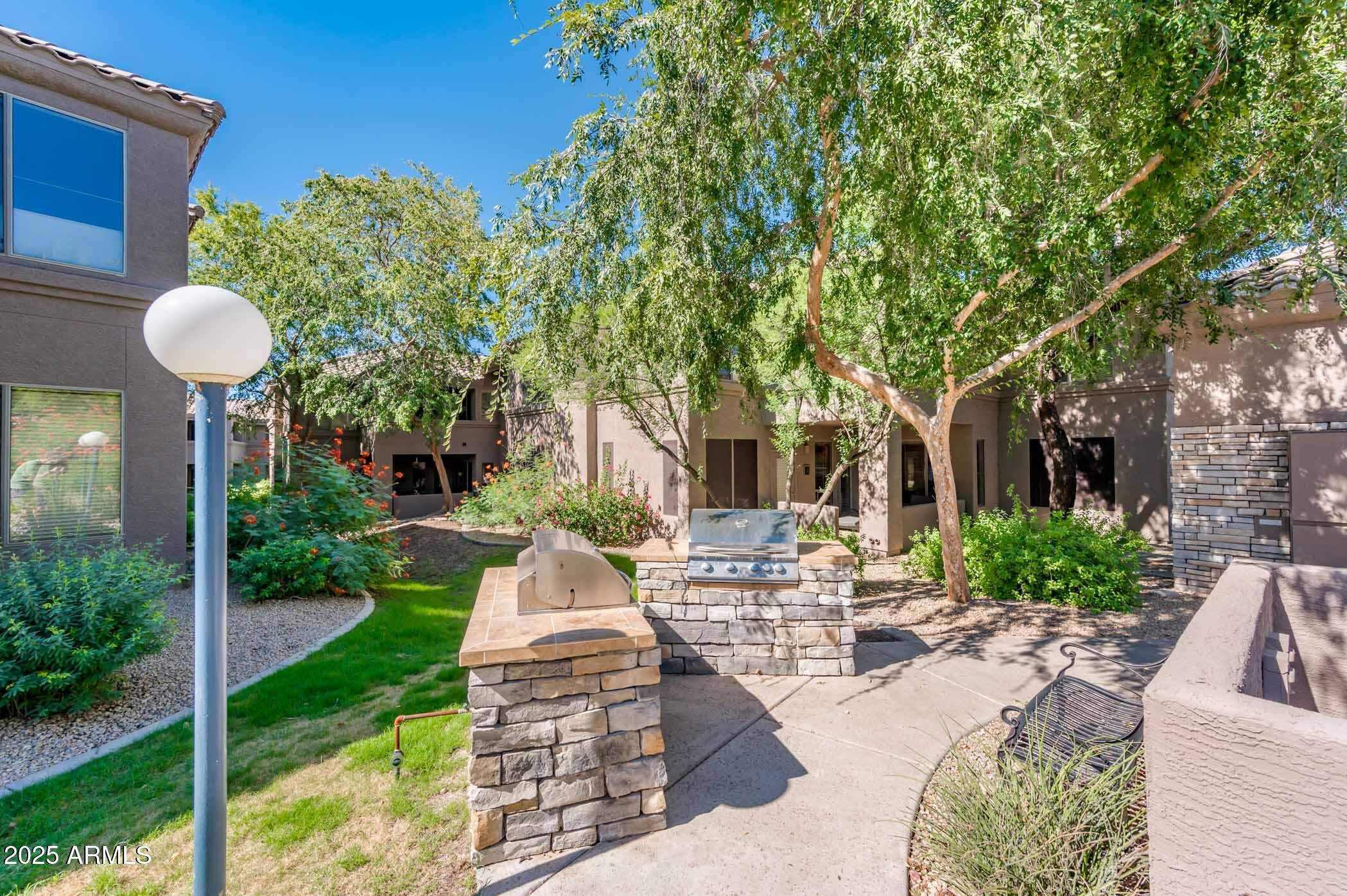 11680 East Sahuaro Drive, Unit 2021 Scottsdale, AZ 85259 - Photo 11 of 51 a view of a patio with couches table and chairs and potted plants