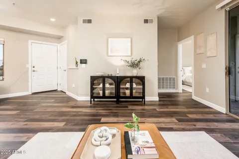 a living room with furniture and a potted plant