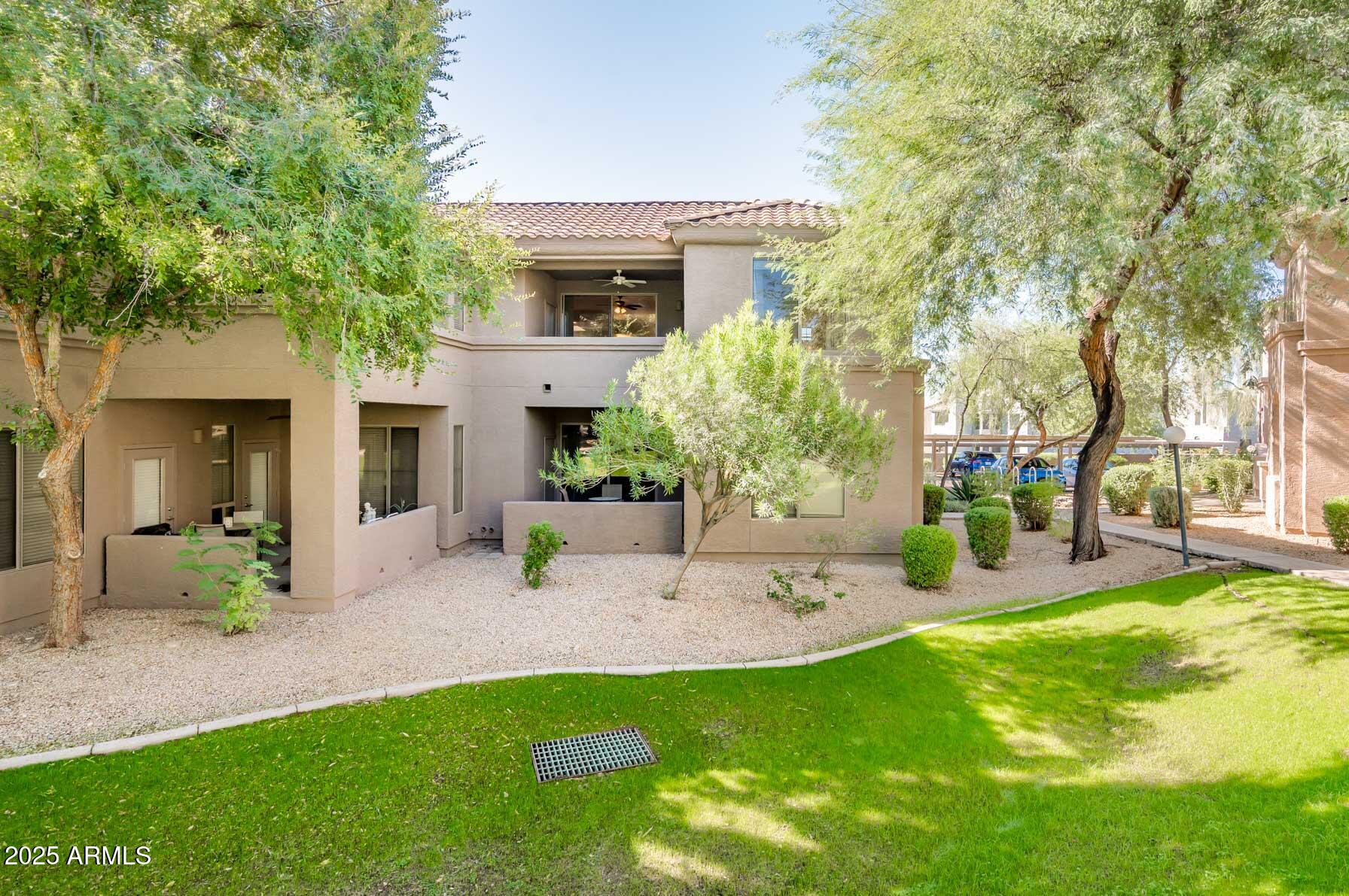 11680 East Sahuaro Drive, Unit 2021 Scottsdale, AZ 85259 - Photo 23 of 51 a view of a house with patio and a garden