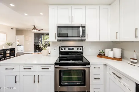 a kitchen with a refrigerator sink and cabinets