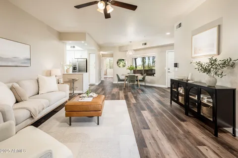 a living room with furniture and wooden floor