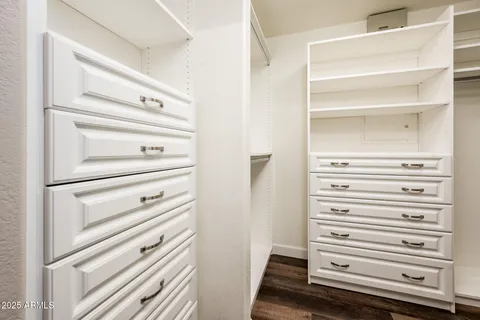 a view of walk in closet with empty racks