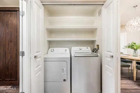 a view of a patio with table and chairs and potted plants