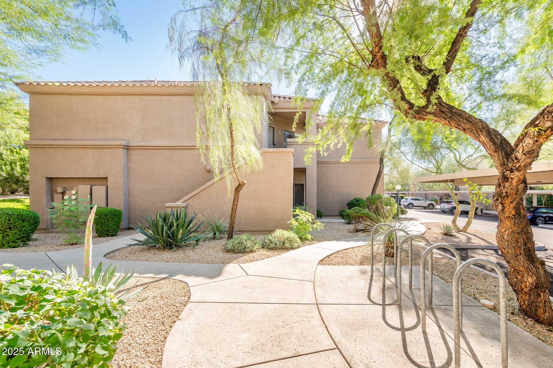 11680 East Sahuaro Drive, Unit 2021 Scottsdale, AZ 85259 - Photo 43 of 51 a view of a patio with table and chairs and potted plants