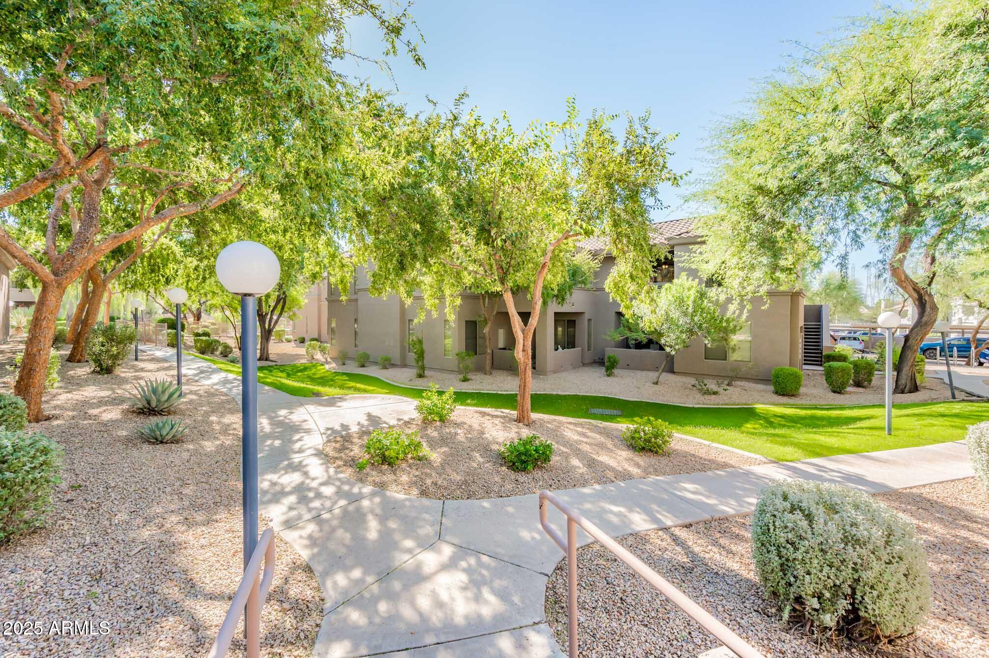 11680 East Sahuaro Drive, Unit 2021 Scottsdale, AZ 85259 - Photo 46 of 51 a front view of a house with garden and trees